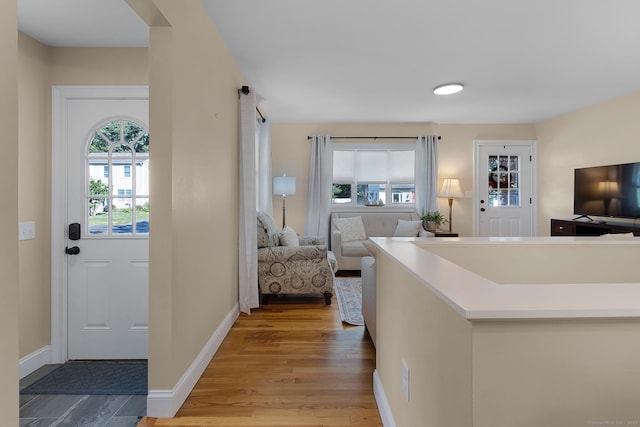 entryway with light wood-style flooring and baseboards