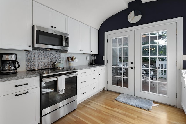 kitchen with white cabinets, stainless steel appliances, french doors, and light wood-style floors