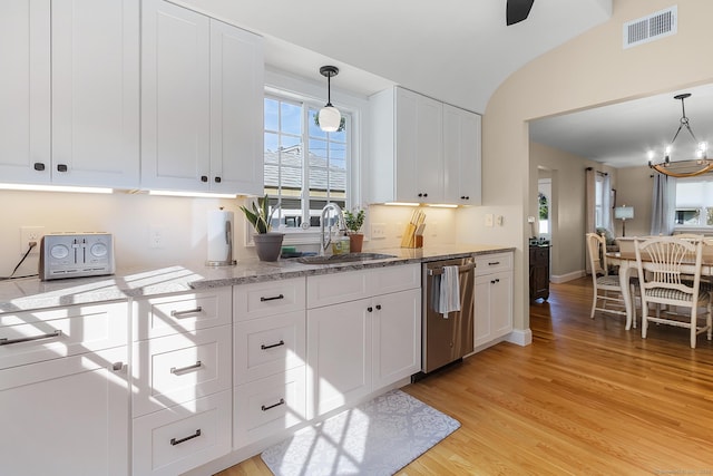 kitchen with visible vents, stainless steel dishwasher, a sink, white cabinets, and light wood-style flooring