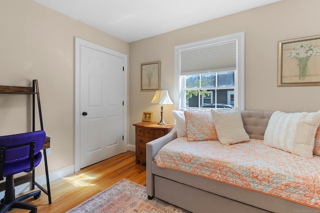 bedroom featuring baseboards and light wood-style floors