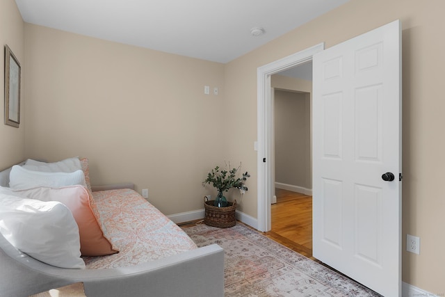 bedroom with light wood-style floors and baseboards