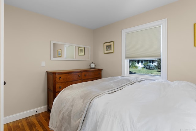 bedroom featuring baseboards and wood finished floors