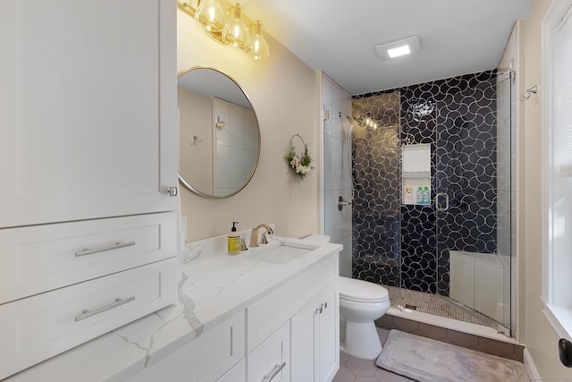full bathroom featuring vanity, toilet, tile patterned flooring, and a tile shower