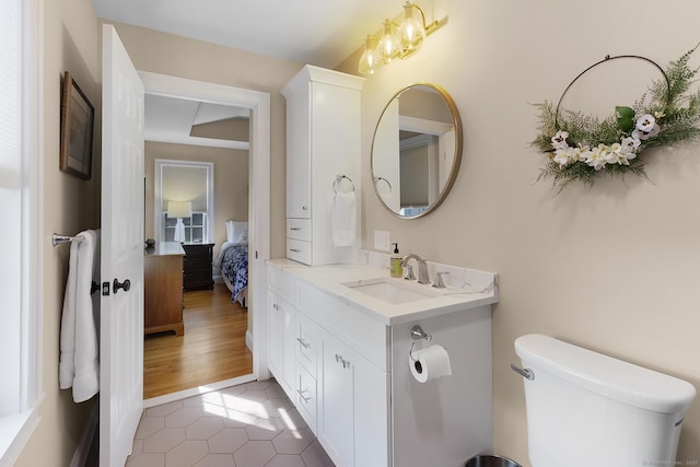bathroom with ensuite bath, toilet, tile patterned flooring, and vanity