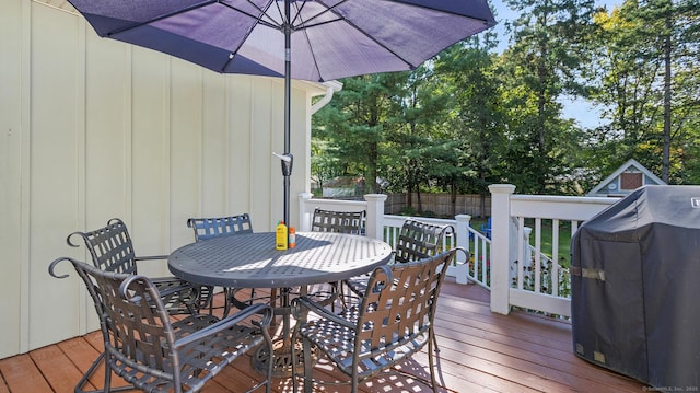wooden deck featuring area for grilling and outdoor dining area