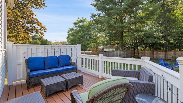 wooden terrace with a fenced backyard and outdoor lounge area
