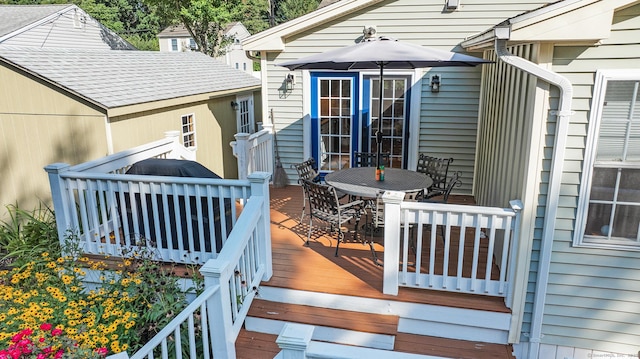 wooden terrace with outdoor dining space