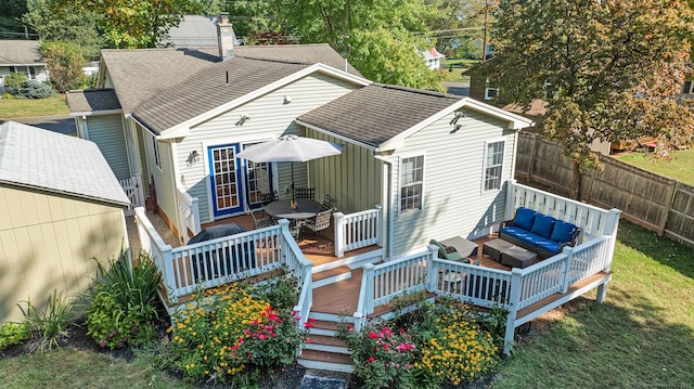 rear view of property featuring a chimney, fence, a wooden deck, an outdoor hangout area, and roof with shingles