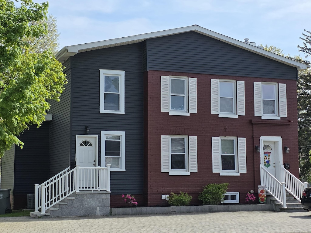 view of front of house featuring brick siding and entry steps