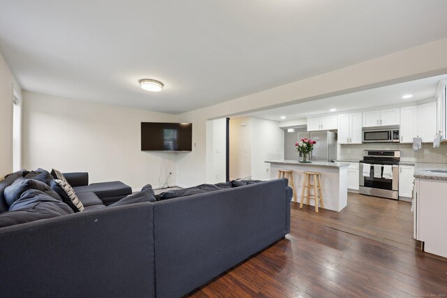 38 Broad St, Plainville, CT 06062 - living room featuring dark wood-type flooring and recessed lighting