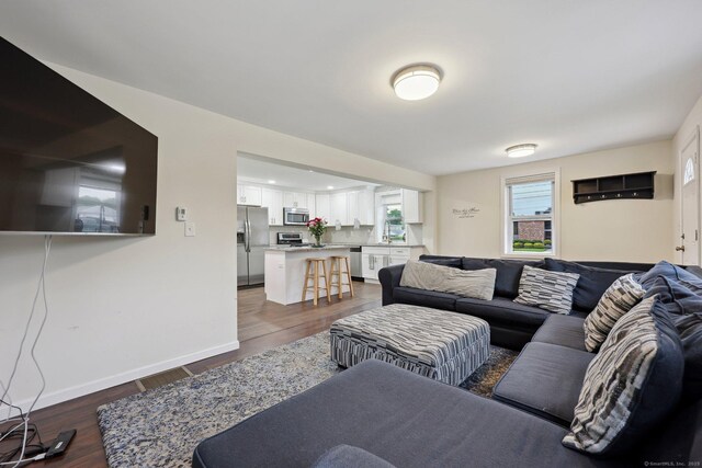 38 Broad St, Plainville, CT 06062 - living room featuring dark wood-style flooring and baseboards