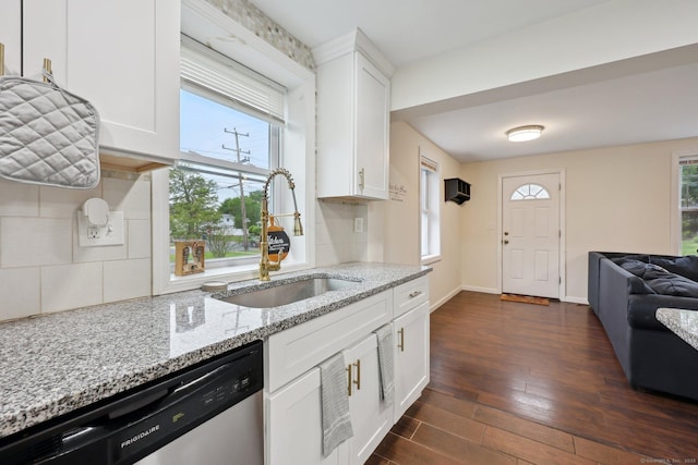 38 Broad St, Plainville, CT 06062 - kitchen featuring dishwasher, a sink, dark wood-style floors, light stone counters, and white cabinetry