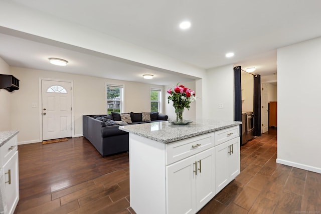 38 Broad St, Plainville, CT 06062 - kitchen featuring dark wood-style flooring, light stone counters, white cabinets, recessed lighting, and a kitchen island