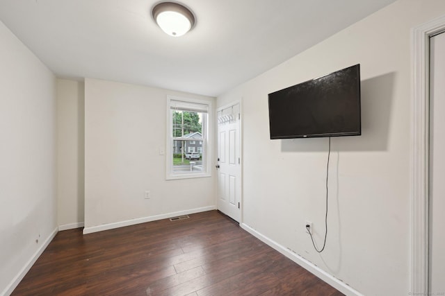 38 Broad St, Plainville, CT 06062 - unfurnished bedroom with dark wood finished floors and baseboards