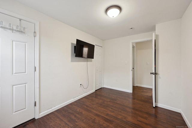 38 Broad St, Plainville, CT 06062 - unfurnished bedroom featuring dark wood-type flooring and baseboards