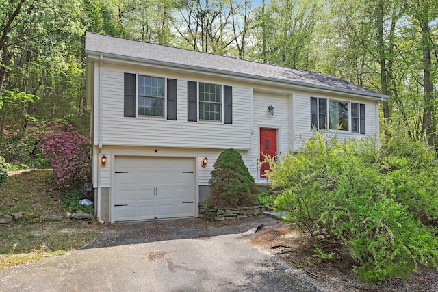 split foyer home with an attached garage and driveway