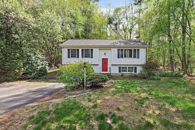 raised ranch with a front yard