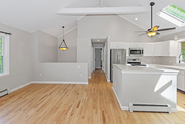 kitchen featuring baseboard heating, high vaulted ceiling, light countertops, white cabinetry, and stainless steel appliances
