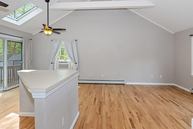 interior space featuring ceiling fan, light wood finished floors, lofted ceiling with skylight, and cooling unit