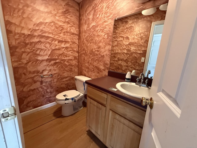 123 Hidden Valley Dr, Meriden, CT 06451 - half bathroom with vanity, wood finished floors, toilet, and wallpapered walls