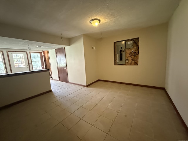 123 Hidden Valley Dr, Meriden, CT 06451 - empty room featuring baseboards, light tile patterned floors, and electric panel