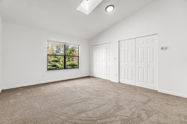 15 Crest St Unit D27, West Haven, CT 06516 - unfurnished bedroom featuring a skylight, carpet floors, baseboards, high vaulted ceiling, and two closets