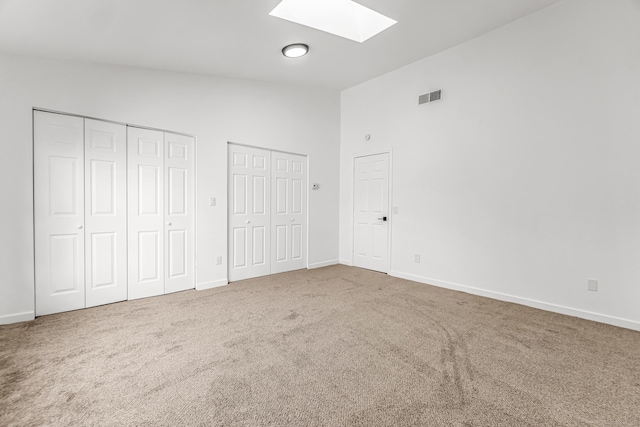 15 Crest St Unit D27, West Haven, CT 06516 - unfurnished bedroom with carpet floors, multiple closets, baseboards, visible vents, and lofted ceiling with skylight