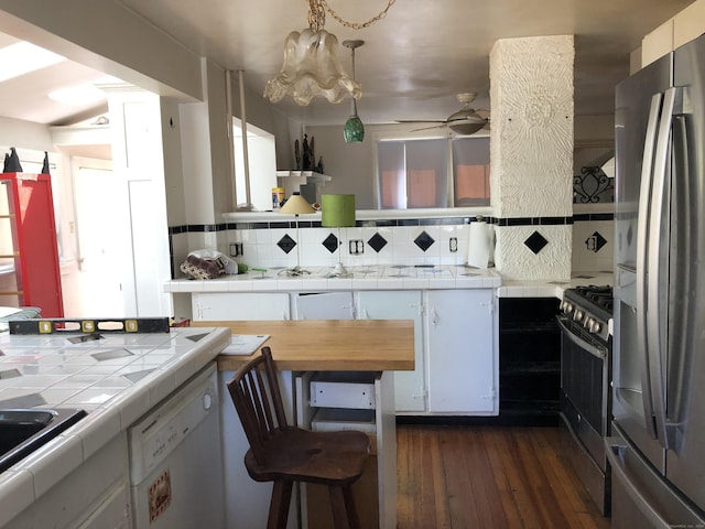 47 Maple Ave, Norfolk, CT 06058 - kitchen with decorative backsplash, tile counters, and stainless steel appliances