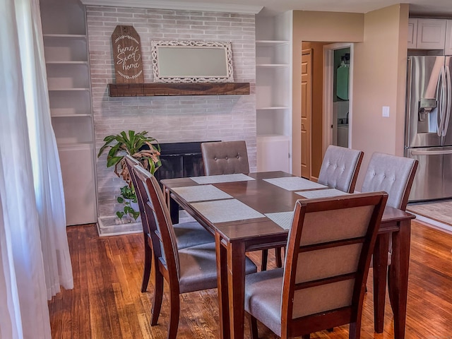63 Ridgetop Rd, Wallingford, CT 06492 - dining space with wood finished floors, built in features, and a fireplace