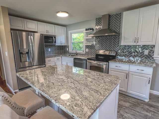 63 Ridgetop Rd, Wallingford, CT 06492 - kitchen featuring appliances with stainless steel finishes, wall chimney range hood, a sink, light stone countertops, and dark wood-style floors