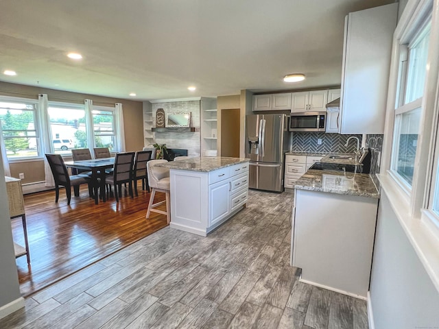 63 Ridgetop Rd, Wallingford, CT 06492 - kitchen featuring stainless steel appliances, wood finished floors, white cabinetry, a center island, and recessed lighting