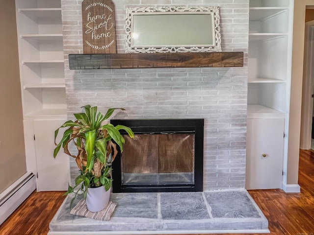 63 Ridgetop Rd, Wallingford, CT 06492 - detailed view of baseboard heating, a fireplace, wood finished floors, and built in features