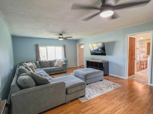63 Ridgetop Rd, Wallingford, CT 06492 - living room featuring ceiling fan, a textured ceiling, light wood-style floors, and a baseboard heating unit