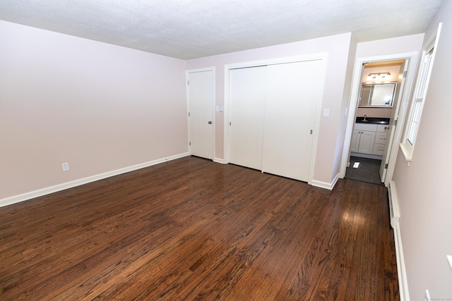 144 Fiesta Hts, Meriden, CT 06451 - unfurnished bedroom featuring dark wood-style floors, baseboards, and a closet