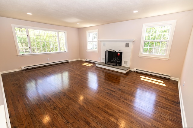 144 Fiesta Hts, Meriden, CT 06451 - unfurnished living room featuring a baseboard heating unit, dark wood-type flooring, a fireplace, and recessed lighting