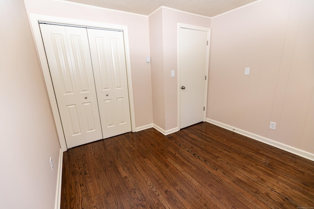 144 Fiesta Hts, Meriden, CT 06451 - unfurnished bedroom with dark wood finished floors, baseboards, a closet, and ornamental molding