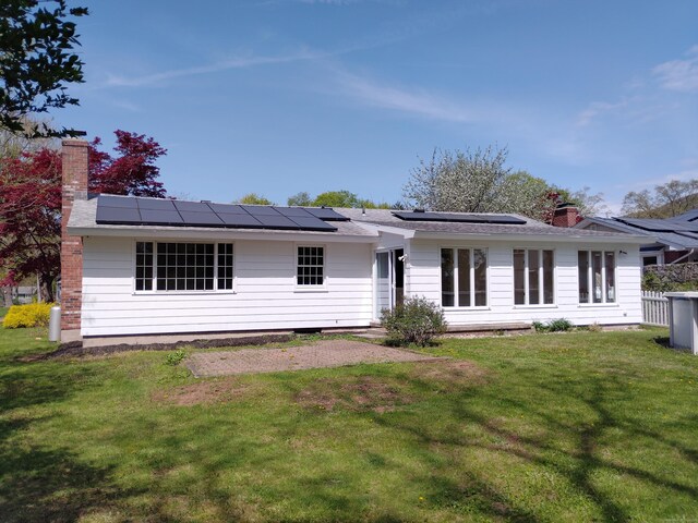 144 Fiesta Hts, Meriden, CT 06451 - back of property featuring solar panels and a yard