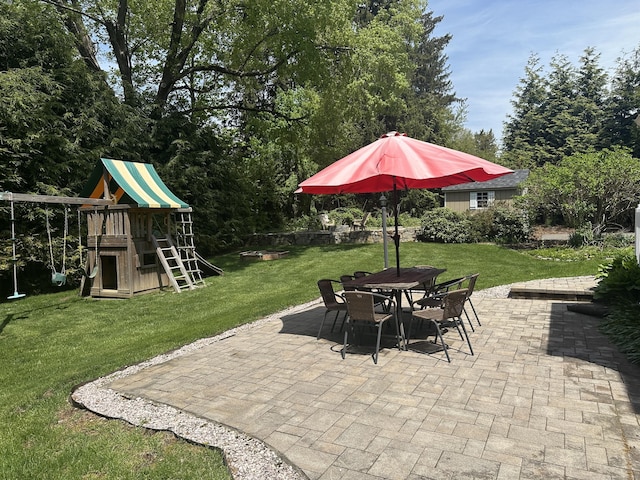 view of patio / terrace with a playground and outdoor dining space