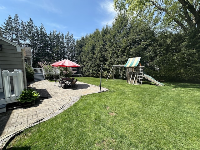 view of yard featuring a playground and a patio area