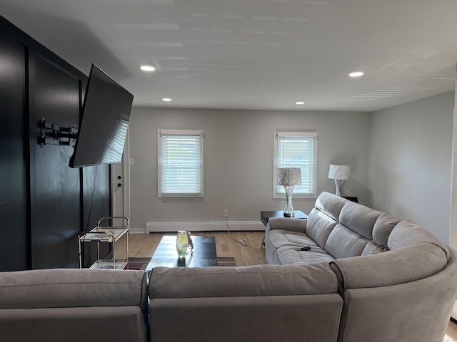 living room featuring recessed lighting, light wood-style flooring, baseboards, and a wealth of natural light