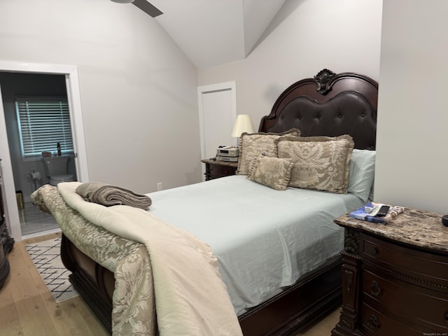 bedroom with vaulted ceiling and light wood finished floors