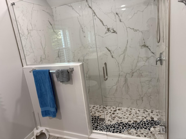 full bathroom featuring baseboards and a marble finish shower