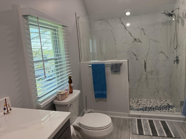 full bathroom with vanity, a marble finish shower, and toilet
