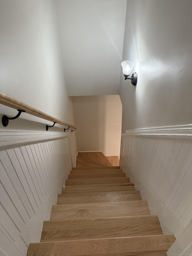 staircase featuring vaulted ceiling