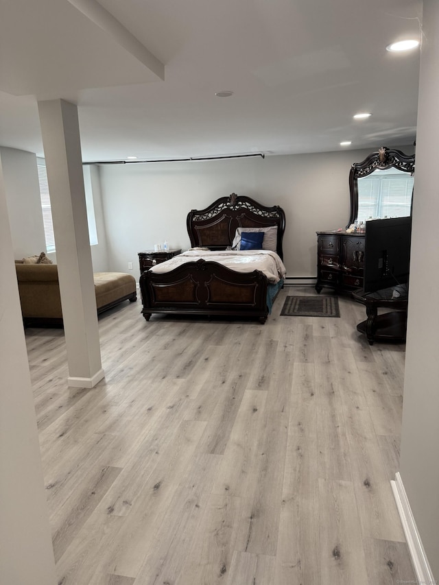 bedroom with recessed lighting, multiple windows, and wood finished floors