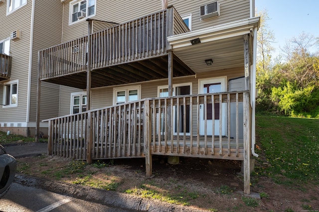 rear view of house featuring a deck and cooling unit