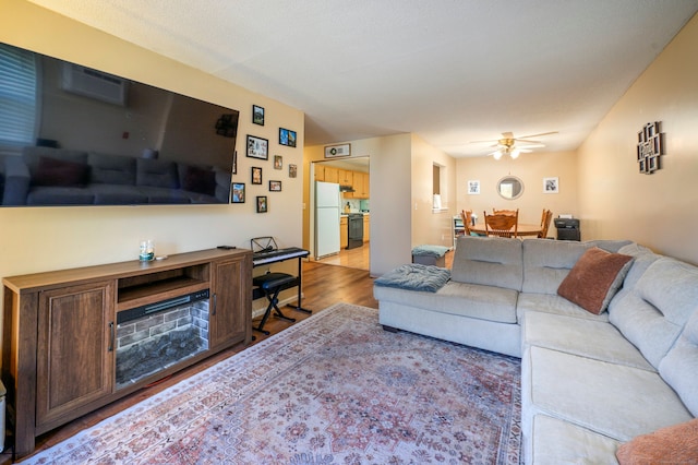 living area featuring a ceiling fan and wood finished floors