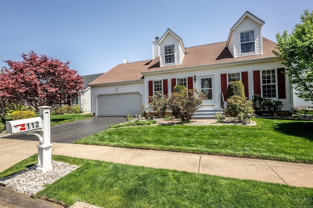 cape cod-style house with a garage, roof with shingles, driveway, and a front lawn