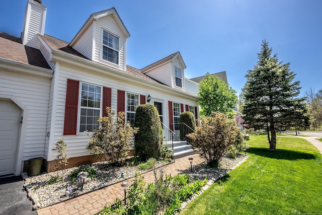 view of front facade featuring a front lawn and a chimney
