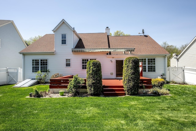 back of property featuring a shingled roof, a wooden deck, a gate, and a fenced backyard